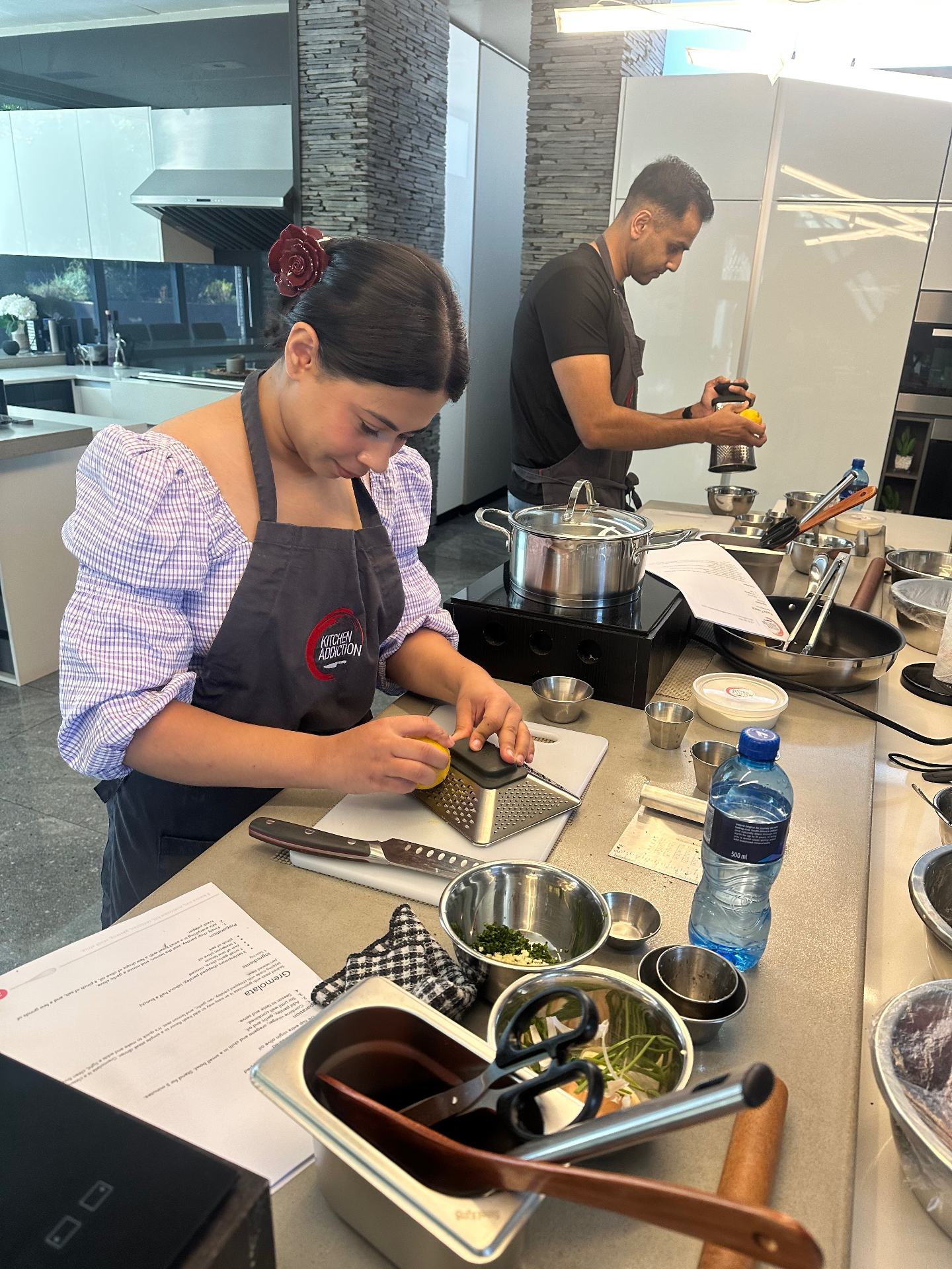 Guests cooking at a Kitchen Addiction class